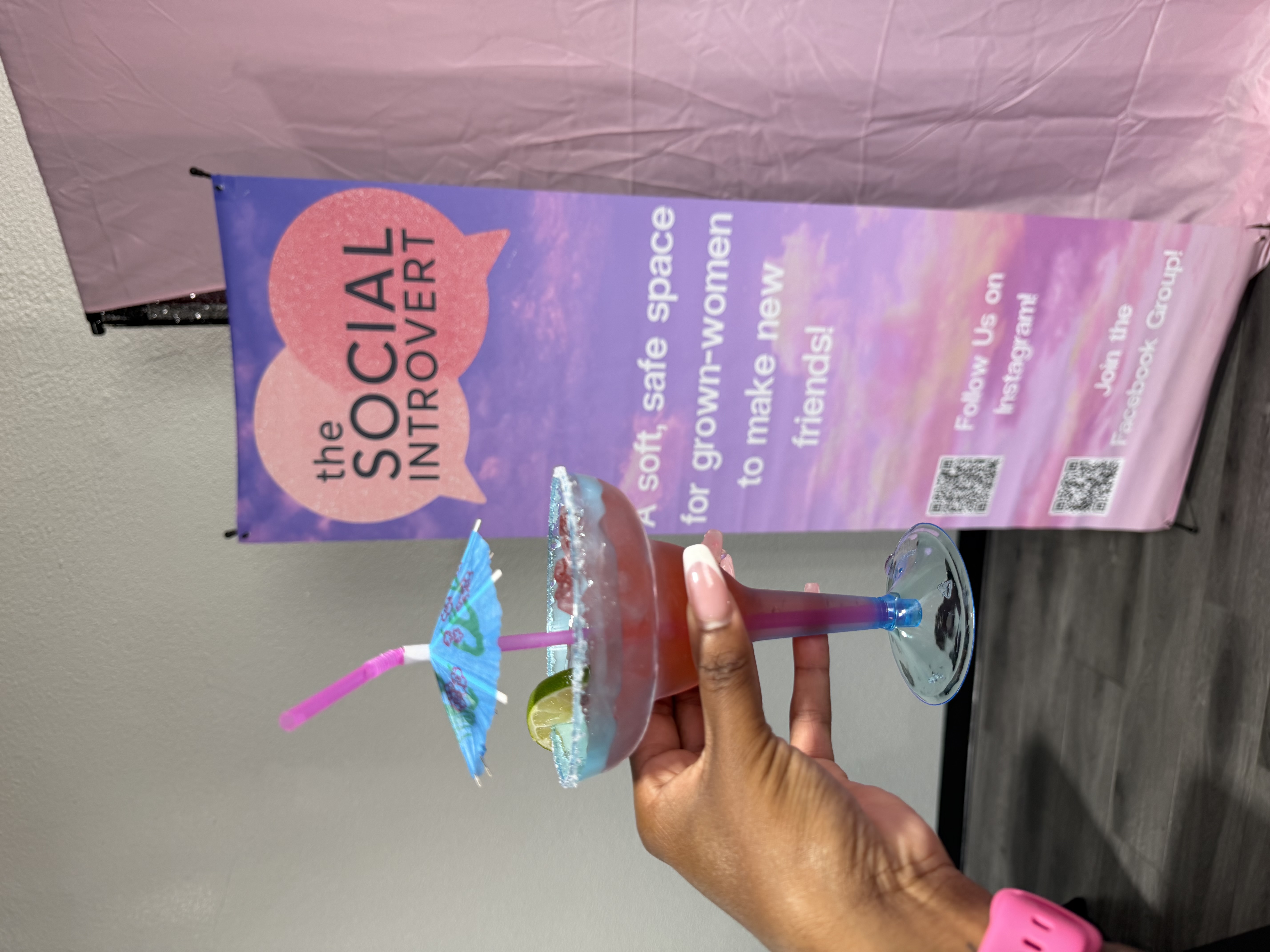 A Social Introvert event welcome banner and celebration drink